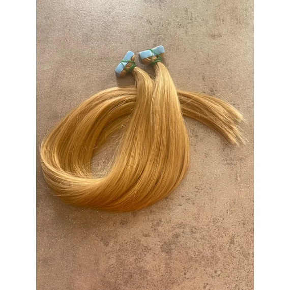 Sötétebb mézszőke festett tape-in (ragasztócsíkos) eredeti haj 60 cm/1pár (2db)